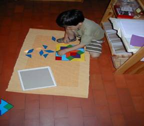 Montessori student shown working on a puzzle.